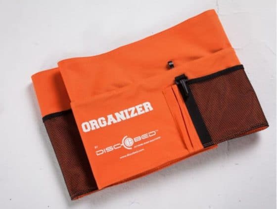 Additional side pocket with hook and loop fastener in orange for the disc bed