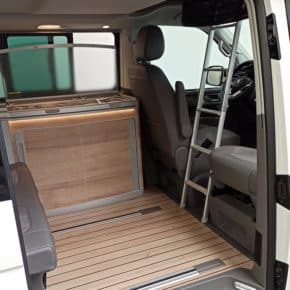 The lightweight, foldable stepBOXX ladder fits between the seats of the VW California models and makes climbing up significantly easier