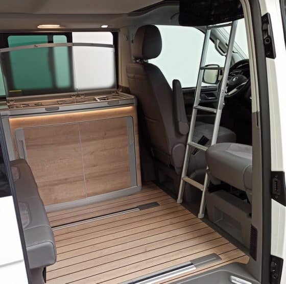 The lightweight, foldable stepBOXX ladder fits between the seats of the VW California models and makes climbing up significantly easier